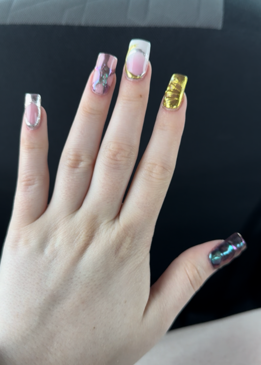 Hand with painted nails against a black and blue background